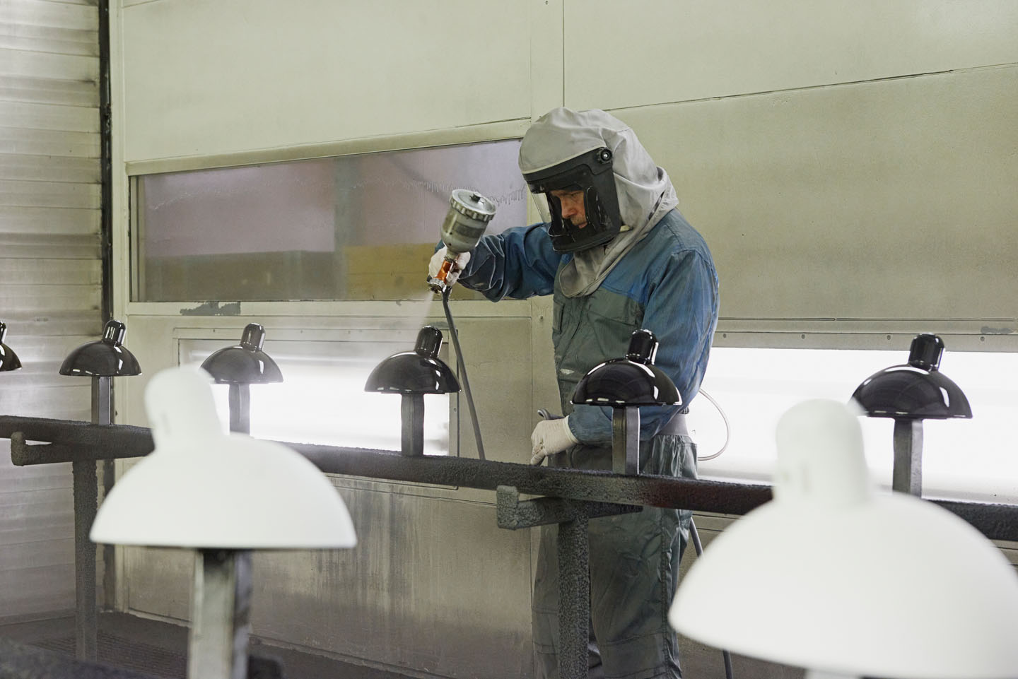 Protected operator spray painting suspended fittings